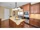 Kitchen boasts an island with a granite countertop and stainless steel fixtures at 10019 Milano Dr, Trinity, FL 34655