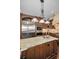 Kitchen island featuring granite counters, seating, and stainless steel appliances at 10019 Milano Dr, Trinity, FL 34655