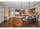 Gourmet kitchen with island seating, custom cabinetry, and stainless steel appliances at 10019 Milano Dr, Trinity, FL 34655
