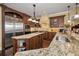Kitchen featuring stainless steel appliances, granite counters, and dark wood cabinets at 10019 Milano Dr, Trinity, FL 34655