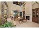 Bright living room with fireplace, large windows, and view of the pool at 10019 Milano Dr, Trinity, FL 34655