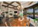 Elegant living room showcasing hardwood floors, fireplace, ceiling beams, and an open floor plan at 10019 Milano Dr, Trinity, FL 34655