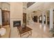 Spacious living room showcasing the fireplace, staircase, and access to other rooms at 10019 Milano Dr, Trinity, FL 34655
