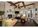 Comfortable living room with a fireplace, ceiling fan, and double doors leading to the outdoors at 10019 Milano Dr, Trinity, FL 34655