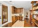 Comfortable office with custom cabinets, dark hardwood floors, and a door to the outside at 10019 Milano Dr, Trinity, FL 34655