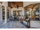 Covered outdoor patio featuring tile floors, comfortable seating, and elegant decor at 10019 Milano Dr, Trinity, FL 34655