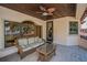 Inviting outdoor patio with comfortable seating, ceiling fan, tile flooring, and views of the water at 10019 Milano Dr, Trinity, FL 34655