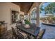 Spacious outdoor patio with an ornate table, chairs, and a serene view of the pool and landscaping at 10019 Milano Dr, Trinity, FL 34655