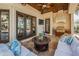 Inviting covered patio with ceiling fans, outdoor grill, comfortable seating, and serene views at 10019 Milano Dr, Trinity, FL 34655