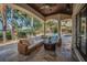 Covered patio with outdoor seating and views of a pool with a waterfall feature at 10019 Milano Dr, Trinity, FL 34655