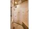 Elegant shower with multiple shower heads, neutral tile, glass door and bench seating at 10019 Milano Dr, Trinity, FL 34655