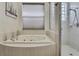Bright bathroom featuring a soaking tub and a glass enclosed shower at 10109 Holly Berry Dr, Spring Hill, FL 34613