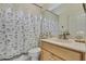 Neutral bathroom showcasing a seashell themed shower curtain at 10109 Holly Berry Dr, Spring Hill, FL 34613