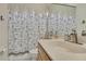 Neutral bathroom showcasing a seashell themed shower curtain at 10109 Holly Berry Dr, Spring Hill, FL 34613
