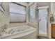 Bright bathroom featuring a soaking tub and a glass enclosed shower at 10109 Holly Berry Dr, Spring Hill, FL 34613