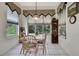 Sunny dining room showcasing large windows overlooking the serene backyard and a charming wine rack at 10109 Holly Berry Dr, Spring Hill, FL 34613