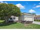 Attractive single-story home boasts a manicured lawn and an attached two-car garage and concrete driveway at 10109 Holly Berry Dr, Spring Hill, FL 34613