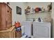 Functional laundry room featuring a washer, dryer, and ample storage at 10109 Holly Berry Dr, Spring Hill, FL 34613