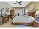 Spacious bedroom featuring wood flooring, tray ceiling, and classic furnishings at 10109 Holly Berry Dr, Spring Hill, FL 34613