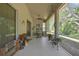 Enclosed back porch overlooking the lush greenery with multiple seating options at 10109 Holly Berry Dr, Spring Hill, FL 34613
