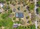 Aerial view of property featuring pool, backyard, and home in a private and lushly landscaped neighborhood at 10645 Fawn Dr, New Port Richey, FL 34654