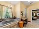 Relaxing bathroom featuring a soaking tub, granite countertop vanity, and natural light at 10645 Fawn Dr, New Port Richey, FL 34654