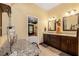 Bright bathroom featuring double sinks, granite countertops, and ceramic tile floors at 10645 Fawn Dr, New Port Richey, FL 34654