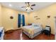 Light and airy bedroom featuring hardwood floors, bright walls, and a ceiling fan at 10645 Fawn Dr, New Port Richey, FL 34654