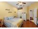 Bedroom with wood flooring, ceiling fan and ensuite bathroom at 10645 Fawn Dr, New Port Richey, FL 34654