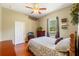 Comfortable bedroom with a floral bedspread, TV, and natural light from the window at 10645 Fawn Dr, New Port Richey, FL 34654