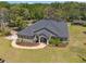 Aerial view of the property featuring a house with a gray roof, landscaping, and large lot, blending comfort and style at 10645 Fawn Dr, New Port Richey, FL 34654