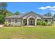 Stunning front exterior showcasing a well-maintained lawn and landscaped flower beds along the walkway to the front door at 10645 Fawn Dr, New Port Richey, FL 34654