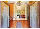 Inviting foyer with hardwood floors, decorative columns, and a chandelier, offering a grand entrance into the home at 10645 Fawn Dr, New Port Richey, FL 34654