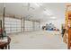 Interior view of the three-car garage with storage and bright lighting at 10645 Fawn Dr, New Port Richey, FL 34654