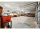 Spacious garage with concrete floors, ample lighting, storage shelves, and an open overhead door at 10645 Fawn Dr, New Port Richey, FL 34654