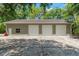 Spacious three-car garage with ample parking space on a concrete pad, perfect for car enthusiasts or storage at 10645 Fawn Dr, New Port Richey, FL 34654