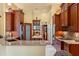 Gourmet kitchen featuring custom cabinets, granite countertops, stainless steel appliances, and an island with seating at 10645 Fawn Dr, New Port Richey, FL 34654