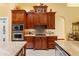 Beautiful kitchen with custom wood cabinets, granite countertops, stainless steel appliances, and designer backsplash at 10645 Fawn Dr, New Port Richey, FL 34654