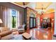 Elegant living room boasts hardwood floors, natural light, and comfortable seating perfect for entertaining or relaxing at 10645 Fawn Dr, New Port Richey, FL 34654