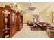Bright living room featuring tile floors, coffered ceilings, leather sectional, and built-in shelving at 10645 Fawn Dr, New Port Richey, FL 34654