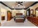 Spacious main bedroom with dark wood furnishings and neutral carpeting at 10645 Fawn Dr, New Port Richey, FL 34654