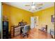 Bright office space with hardwood floors, a ceiling fan, and functional desk setup at 10645 Fawn Dr, New Port Richey, FL 34654