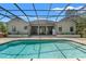 Beautiful screened-in pool area with a spacious patio perfect for outdoor entertaining at 10645 Fawn Dr, New Port Richey, FL 34654