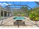 Relaxing pool and patio area featuring a fire pit and ample space for outdoor activities at 10645 Fawn Dr, New Port Richey, FL 34654