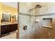 Close up of shower featuring multiple shower heads, tile surround and built in shelf at 10645 Fawn Dr, New Port Richey, FL 34654