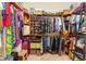 Spacious walk-in closet with custom shelving, shoe racks, and ample storage space at 10645 Fawn Dr, New Port Richey, FL 34654