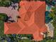 Aerial view of a sprawling home with a clay tile roof, pool and lush landscaping at 10712 Pontofino Cir, Trinity, FL 34655