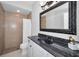 Traditional bathroom featuring granite countertop, dark fixtures and a shower at 10712 Pontofino Cir, Trinity, FL 34655