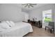 Bedroom with light wood floors, soft natural light, and neutral gray walls at 10712 Pontofino Cir, Trinity, FL 34655