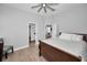 Bedroom featuring a ceiling fan and view to the en-suite bathroom and living area at 10712 Pontofino Cir, Trinity, FL 34655